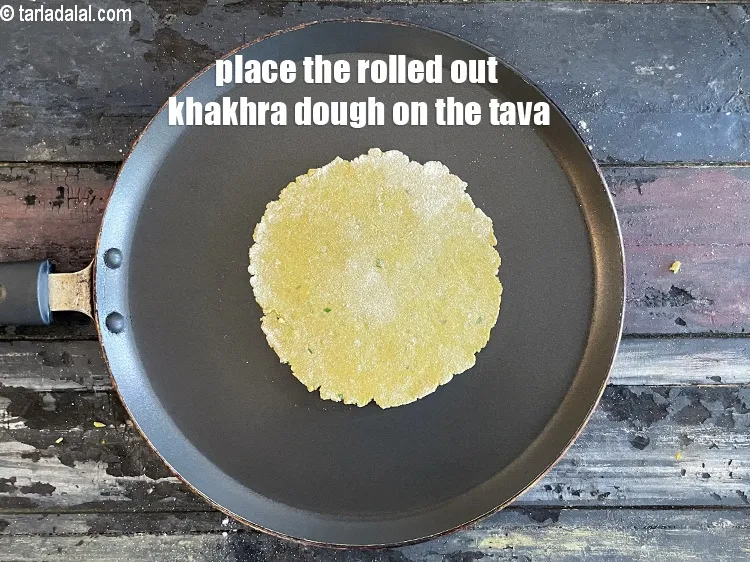 Step 19 – Place the rolled out&nbsp;<strong>Khakhra</strong>&nbsp;dough on it.