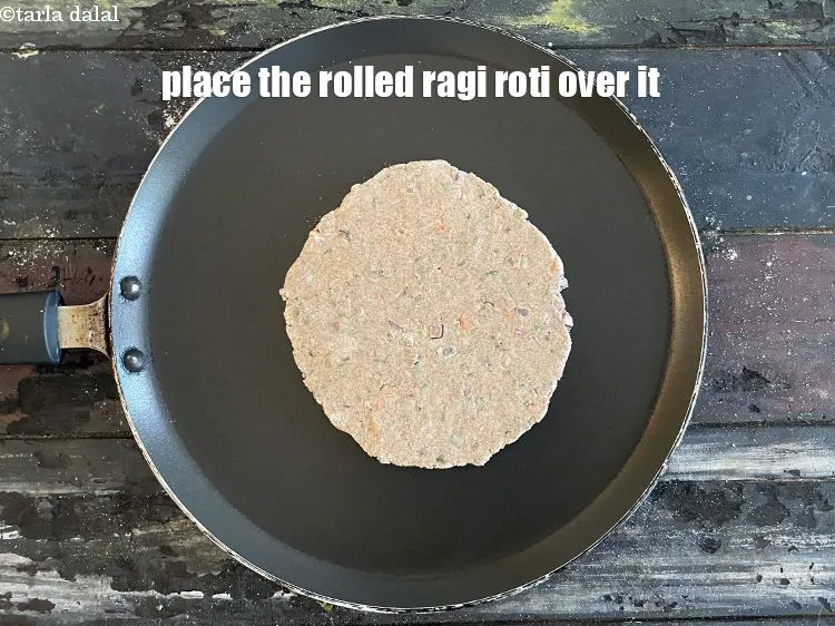 Step 19 – <meta charset="UTF-8" />When the non stick tava is hot place the Ragi roti gently over …