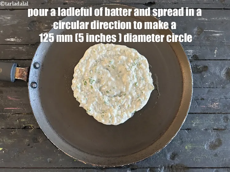 Step 19 – Pour a ladleful of the batter and spread in a circular motion to make a …
