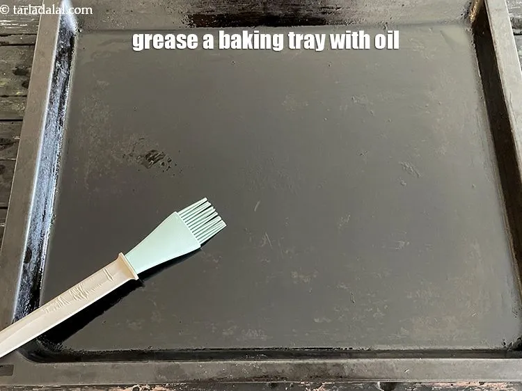 Step 20 – <meta charset="UTF-8" />Grease a baking tray using &frac14; tsp of oil.