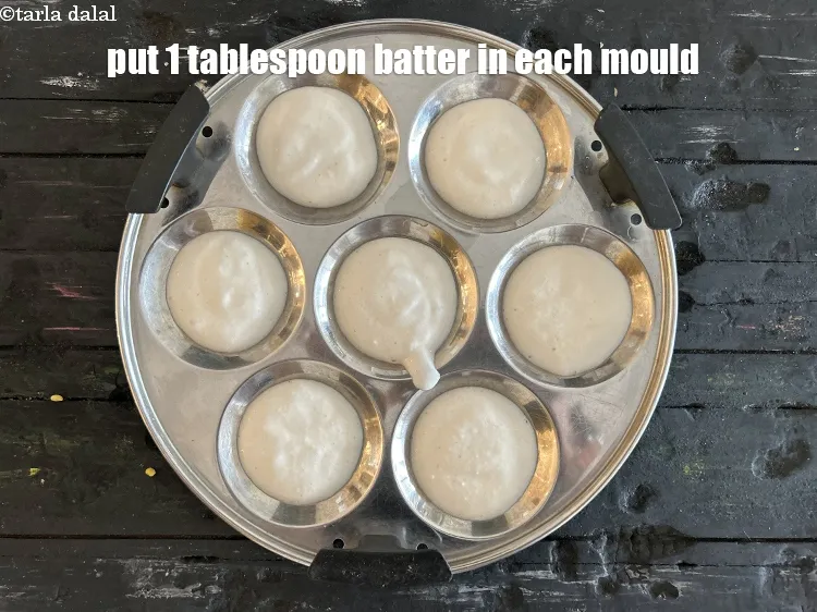 Step 19 – Put 1 tbsp of the idli batter on each idli mould.