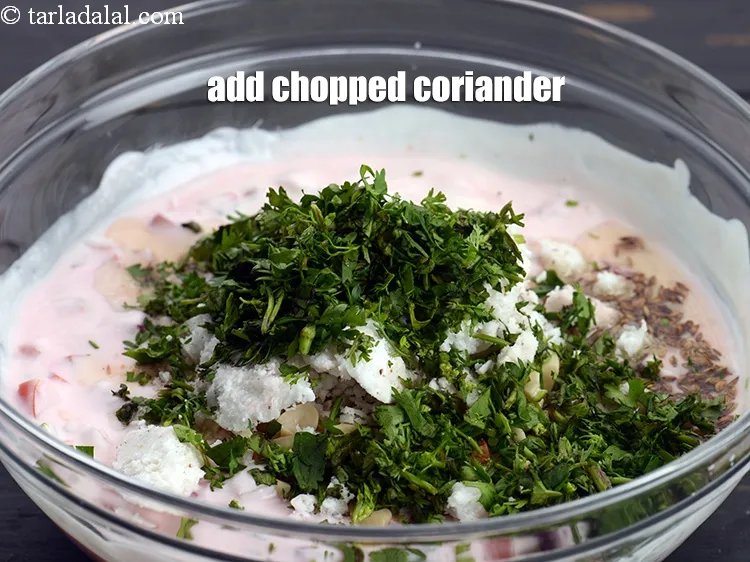 Step 19 – Add &frac14; cup <a href="https://www.tarladalal.com/glossary-chopped-coriander-783i">chopped coriander (dhania)</a>.