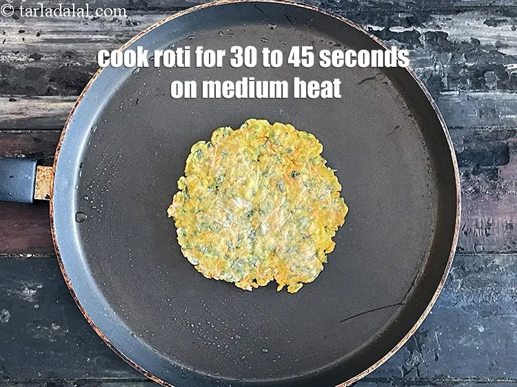 Step 19 – <html><head><meta charset="UTF-8"></head><body><p>Cook roti for 30 to 45 seconds on a medium flame.&nbsp;</p></body></html>