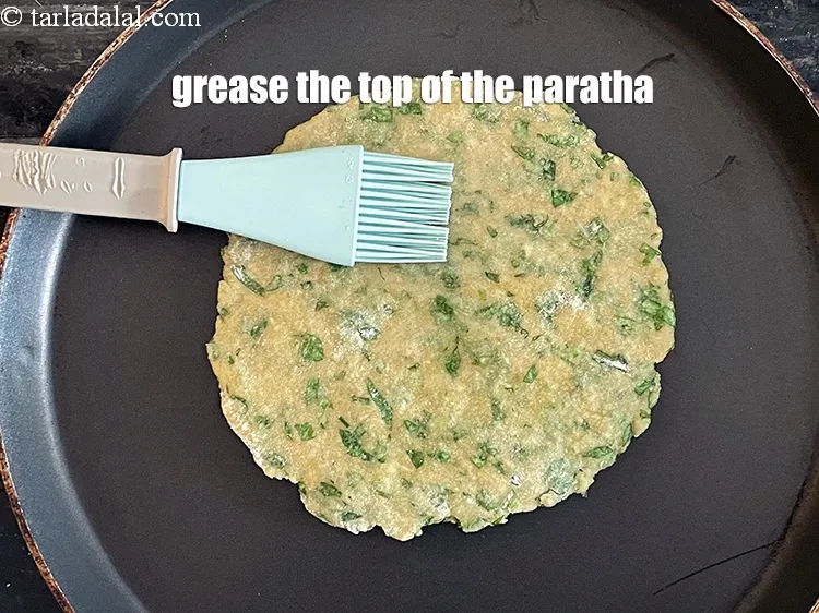 Step 20 – <meta charset="UTF-8" />Then grease the top of the roti with little oil.&nbsp;&nbsp;<br /> &nbsp;