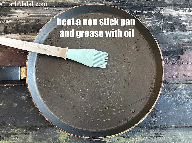 Step 19 – <meta charset="UTF-8" />Heat a non-stick tava (griddle) and grease it will little oil.&nbsp;