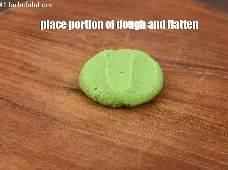 Step 19 – Place a portion of dough on rolling board and flatten it slightly.