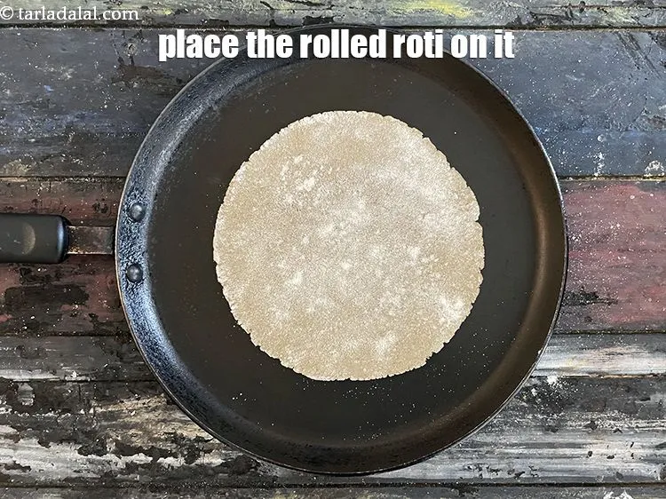 Step 22 – Place the rolled roti on the tava.