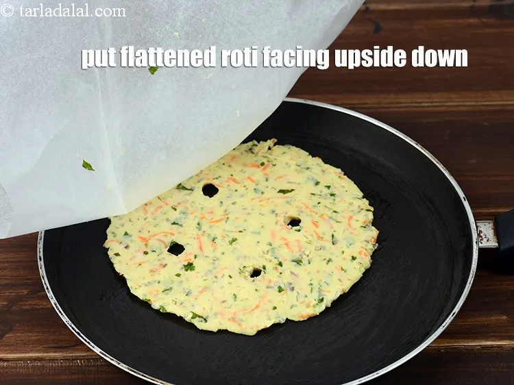 Step 18 – Put the flattened roti facing upside down and gently remove the butter paper.