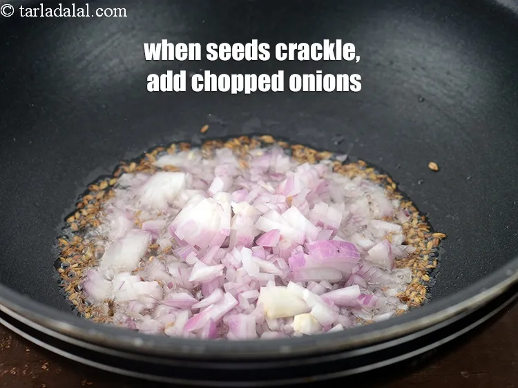 Step 19 – When the seeds crackle, add &frac12; cup <a href="https://www.tarladalal.com/glossary-chopped-onions-722i">chopped onions</a>.