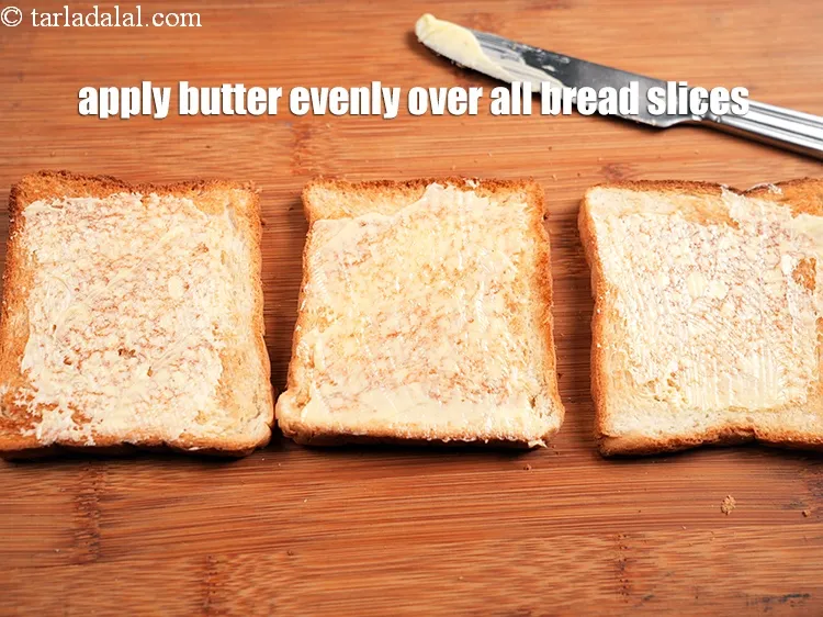 Step 21 – Apply 1 tsp of <a href="https://www.tarladalal.com/glossary-butter-makhan-233i">butter</a> evenly over all the bread slices.