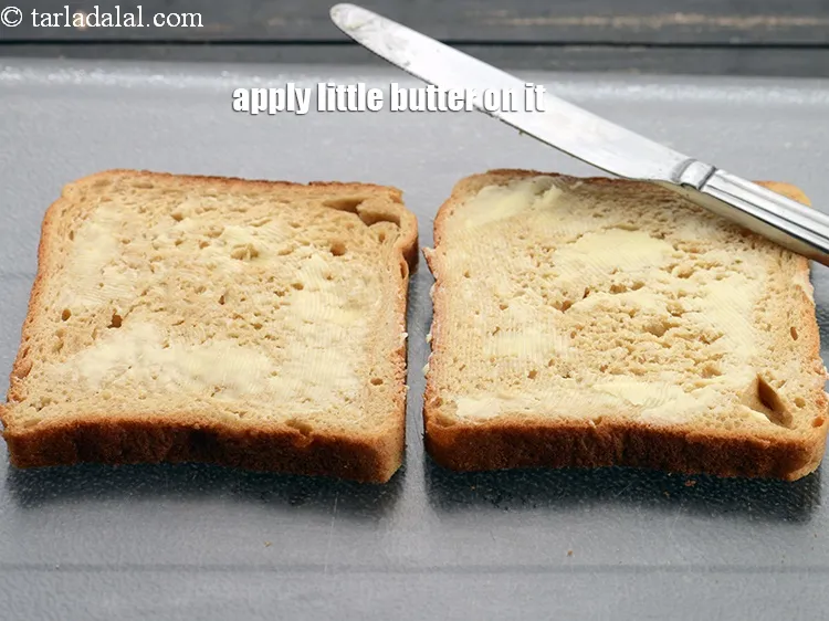 Step 19 – Apply little <a href="https://www.tarladalal.com/glossary-butter-makhan-233i">butter</a>&nbsp;on both bread slices.