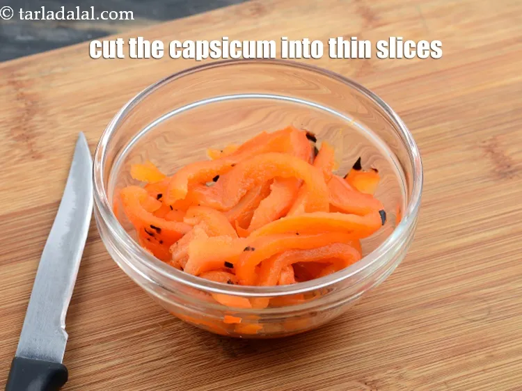 Step 20 – Cut the capsicum into thin slices using a sharp knife. Keep aside.