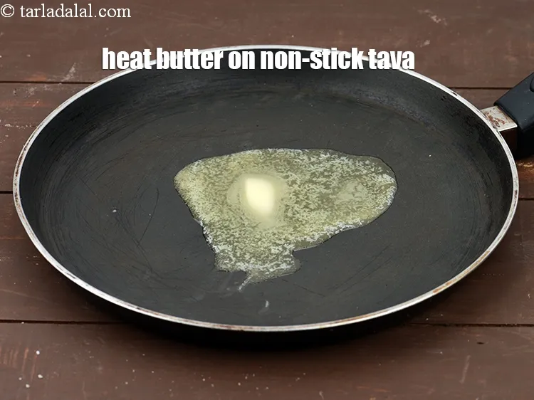 Step 19 – Heat 1 tsp of <a href="https://tarladalal.com/glossary-butter-makhan-233i">butter</a>&nbsp;on a non-stick tava (griddle).