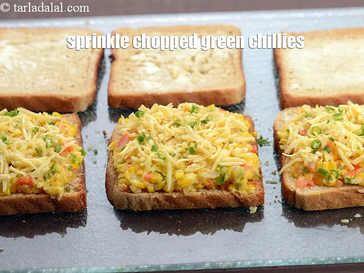 Step 19 – Sprinkle &frac14; tsp <a href="https://www.tarladalal.com/glossary-chopped-green-chilli-820i">chopped green chillies</a> evenly over it.