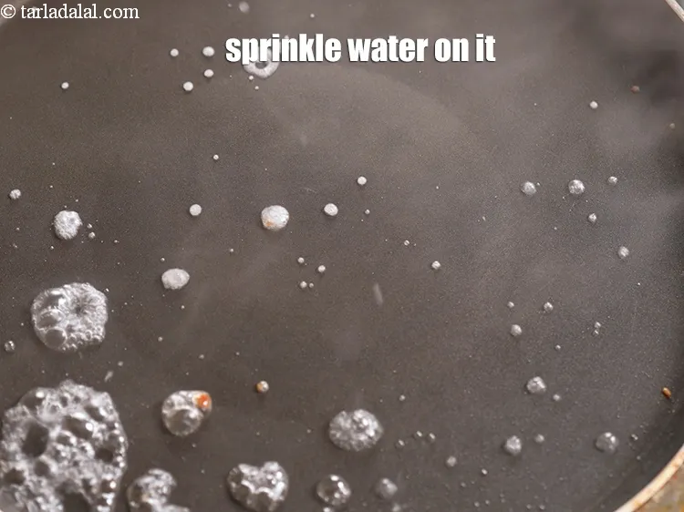 Step 26 – Sprinkle a little water on the tava (griddle).&nbsp;<meta charset="UTF-8" />It should sizzle immediately. Never use …