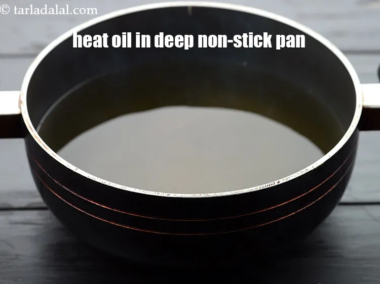 Step 19 – Heat the <a href="https://www.tarladalal.com/glossary-oil-671i">oil</a>&nbsp;in a deep non-stick pan.&nbsp;