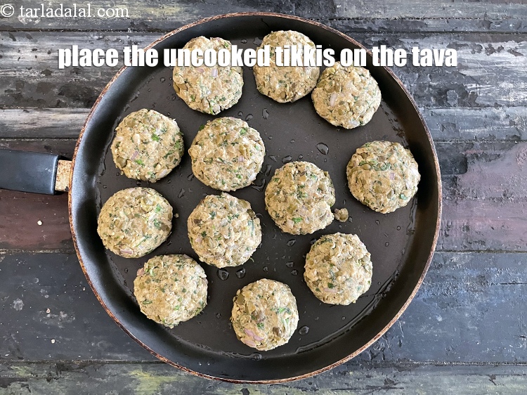 Step 34 – <meta charset="UTF-8" /> Place the uncooked<strong>&nbsp;tikki&#39;s</strong>&nbsp;on the tava.&nbsp;