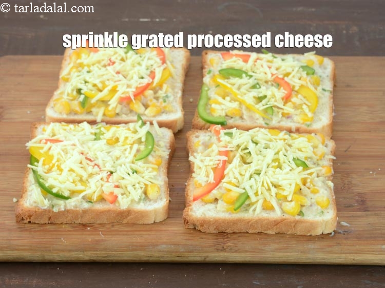 Step 19 – Sprinkle 1 tbsp of <a href="https://www.tarladalal.com/glossary-grated-processed-cheese-868i">grated processed cheese</a> evenly over each bread slice.