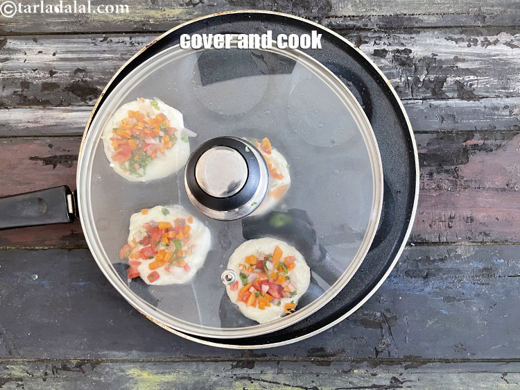 Step 31 – Cover and cook the sooji uttapam on medium flame for 3 minutes.