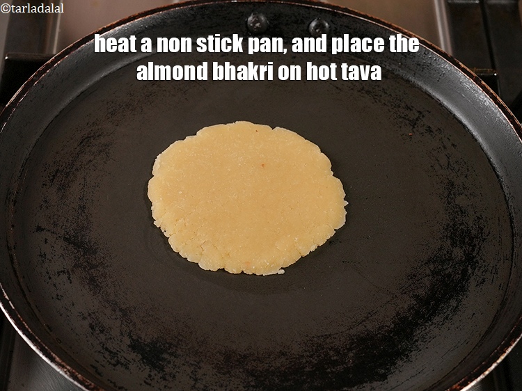 Step 20 – Heat a non stick pan, and place the almond bhakri on hot tava.