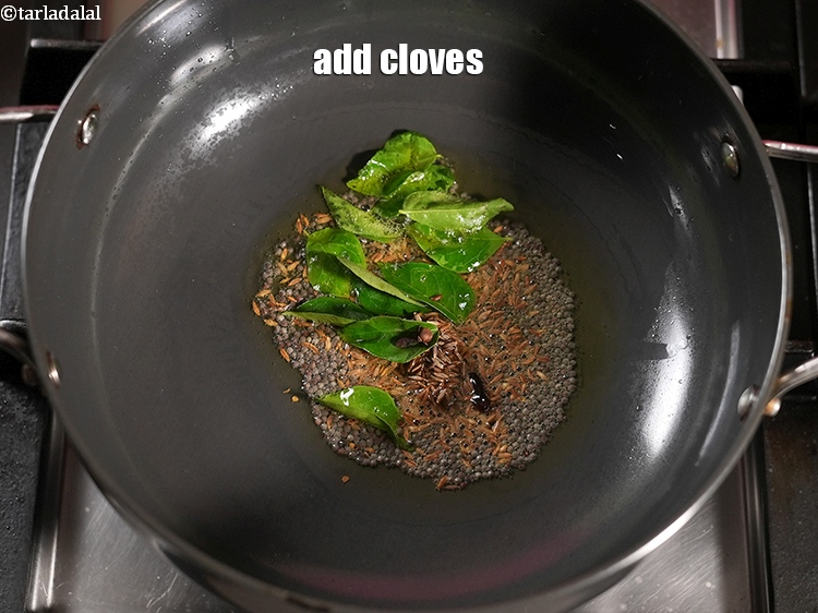 Step 20 – Add 2 <a href="https://www.tarladalal.com/glossary-cloves-laung-lavang-322i">cloves (laung / lavang)</a>.