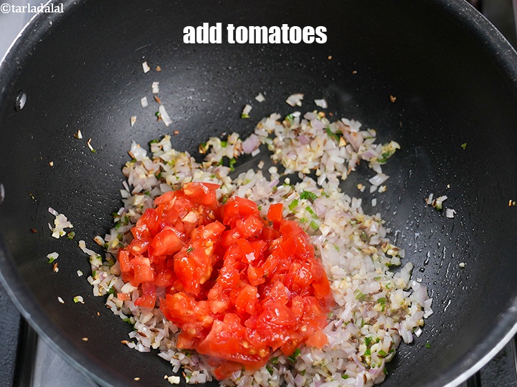 Step 20 – Add &frac12; cup <a href="https://www.tarladalal.com/glossary-chopped-tomatoes-779i">chopped tomatoes</a>.