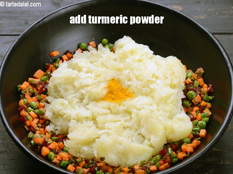 Step 21 – Add &frac14; tsp <a href="https://www.tarladalal.com/glossary-turmeric-powder-haldi-645i">turmeric powder (haldi)</a>.&nbsp;