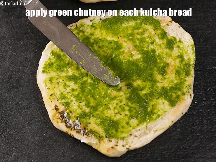 Step 20 – Apply &frac12; tbsp <a href="https://www.tarladalal.com/green-chutney-22266r">green chutney</a> on each kulcha bread.