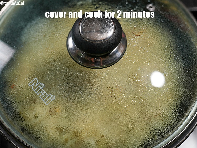 Step 20 – Cover it with a lid and cook on a medium flame for 2 minutes.