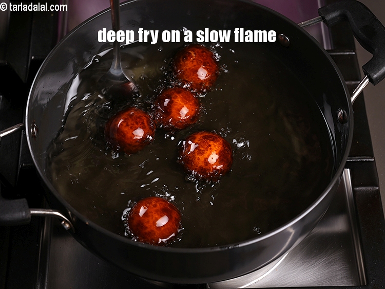 Step 21 – Deep fry them on a slow flame till they turn brown in colour from all …