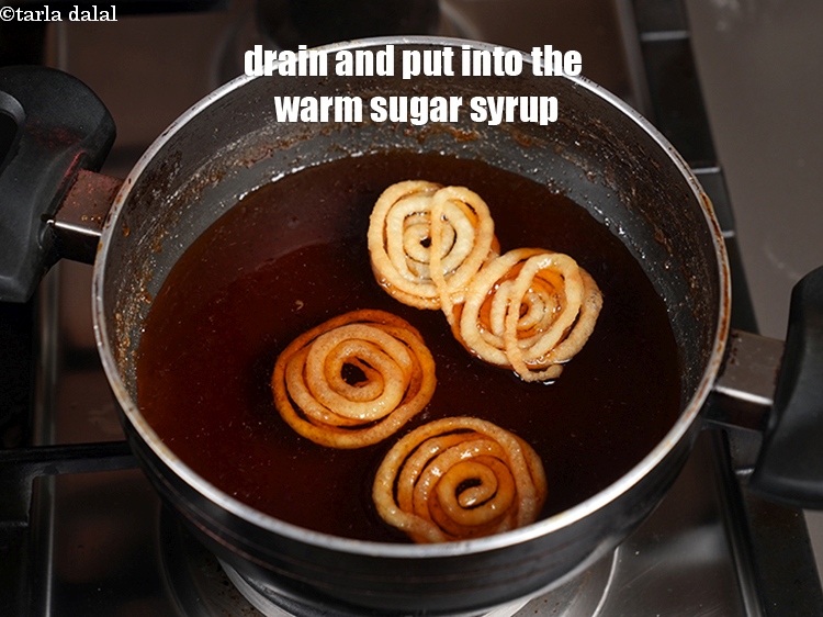 Step 22 – Drain and transfer them into the warm sugar syrup.