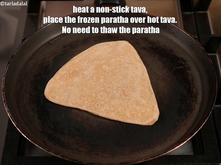 Step 23 – Heat a non-stick tava (griddle), place the frozen paratha over hot tava. No need to …