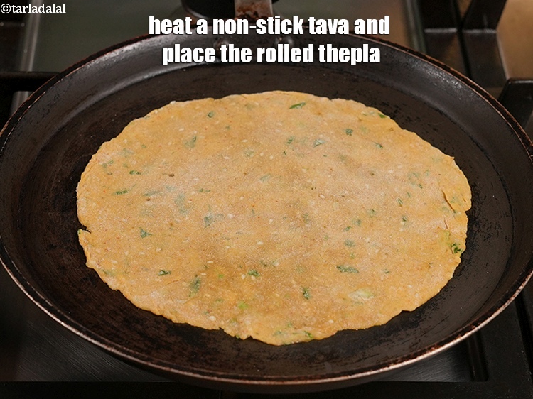 Step 20 – Heat a non-stick tava (griddle) and place the rolled thepla.