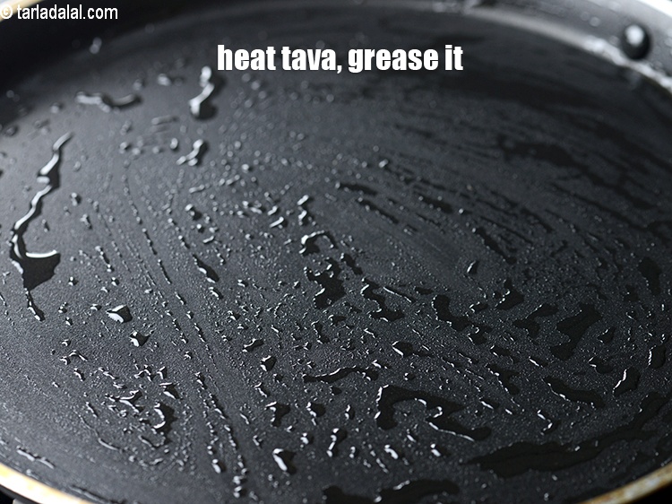 Step 18 – Heat a non-stick tava (griddle), grease it with oil.