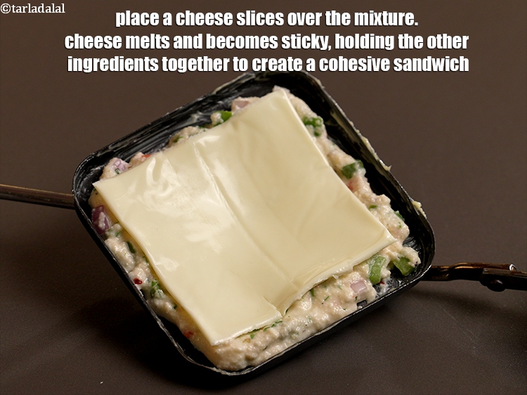 Step 20 – Place a <a href="https://www.tarladalal.com/glossary-cheese-slices-765i">cheese slices</a> over the mixture. Cheese melts and becomes sticky, holding the …