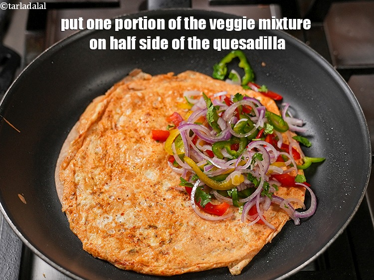 Step 20 – Put one portion of the veggie mixture on half side of the quesadilla.