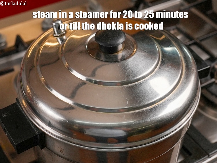 Step 28 – Steam in a steamer for 20 to 25 minutes or till the dhokla&nbsp;is&nbsp;cooked.