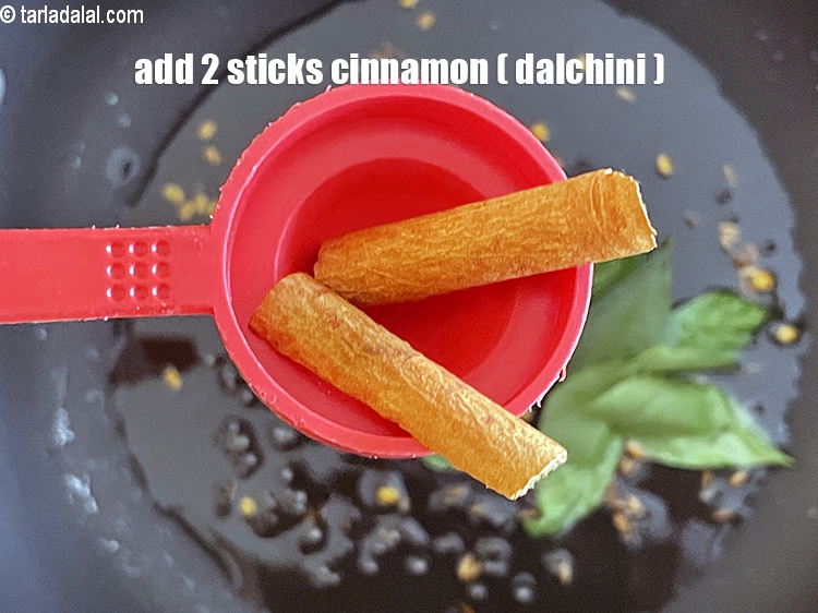 Step 20 – <p>Add<strong> </strong>2 sticks <a href="https://www.tarladalal.com/glossary-cinnamon-dalchini-346i"><strong>cinnamon (dalchini)</strong></a><strong>.</strong></p>