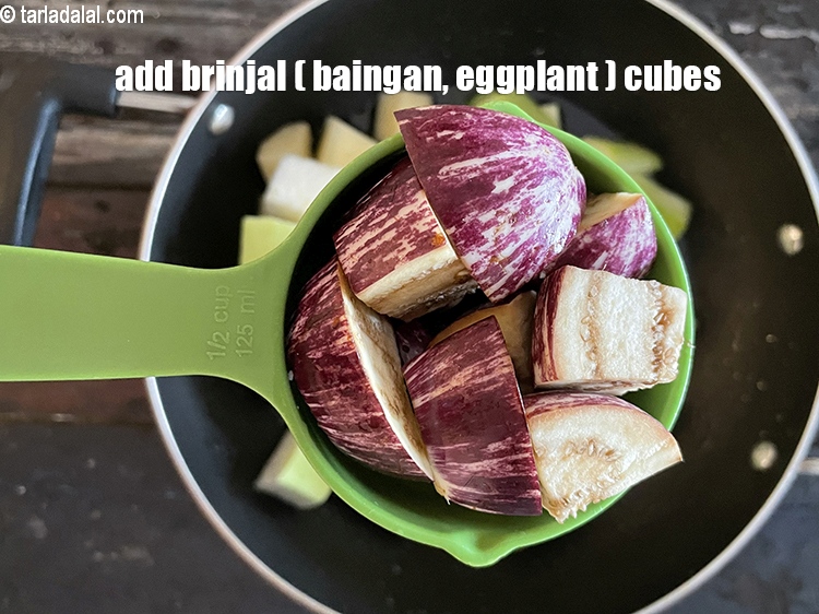 Step 21 – Add&nbsp;<meta charset="UTF-8" />1/2 cup&nbsp;<a href="glossary-brinjal-cubes-132i">brinjal (baingan / eggplant) cubes</a>.