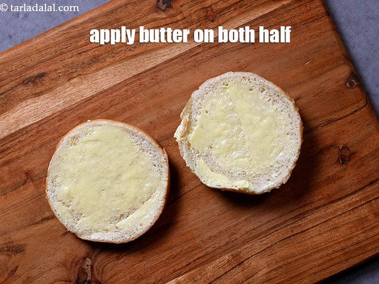Step 27 – Apply <a href="https://www.tarladalal.com/glossary-butter-makhan-233i">butter</a>&nbsp;on both the sides of each half of the burger bun.