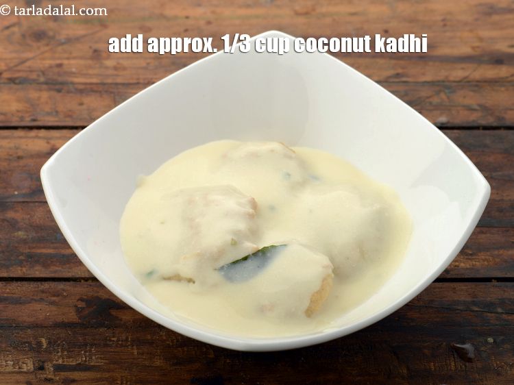 Step 52 – Pour approx. 1/3 cup <a href="https://www.tarladalal.com/coconut-kadhi-2862r" target="_blank">coconut kadhi</a> evenly over it.