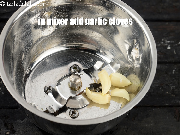 Step 21 – In a mixer add 4 <a href="https://www.tarladalal.com/glossary-garlic-cloves-1857i">garlic (lehsun) cloves</a>.