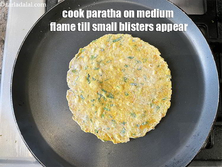 Step 20 – Let the paratha cook on medium flame till small bubbles appear on the paratha which …
