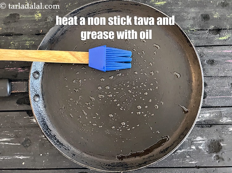 Step 21 – <meta charset="UTF-8" /> Heat a non-stick tava (griddle) and grease with oil.&nbsp;&nbsp;