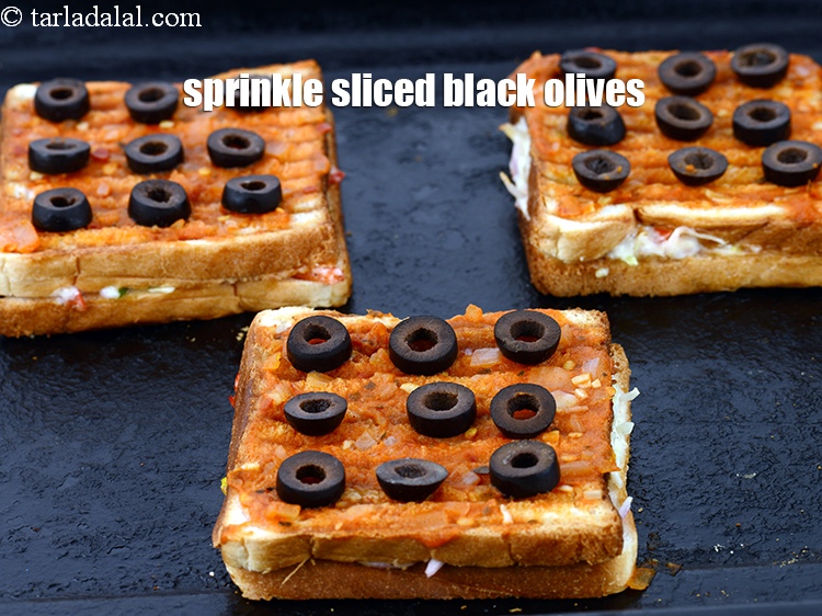 Step 20 – Sprinkle 2 tsp <a href="https://www.tarladalal.com/glossary-sliced-black-olives-1069i">sliced black olives</a>.