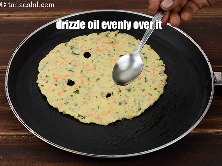 Step 19 – Drizzle &frac12; tsp of <a href="https://www.tarladalal.com/glossary-oil-671i">oil</a>&nbsp;evenly over it.