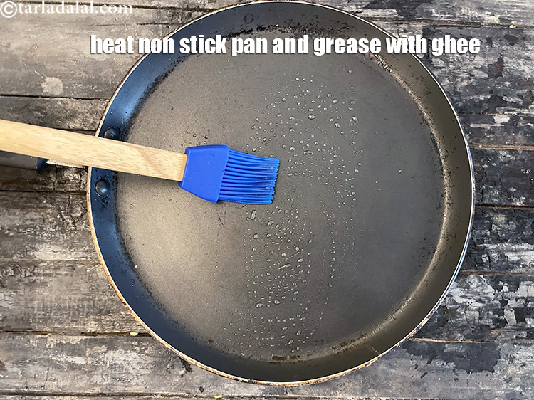 Step 48 – Heat a non stick pan and grease it with ghee.