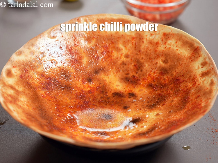 Step 21 – Sprinkle 1 tsp <a href="https://www.tarladalal.com/glossary-chilli-powder-red-chilli-powder-339i">chilli powder</a>.