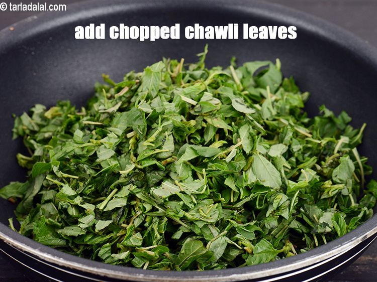 Step 20 – Add 3 cups chopped <a href="https://www.tarladalal.com/glossary-chopped-green-chawli-leaves-2048i">chopped green chawli (amaranth) leaves</a>.