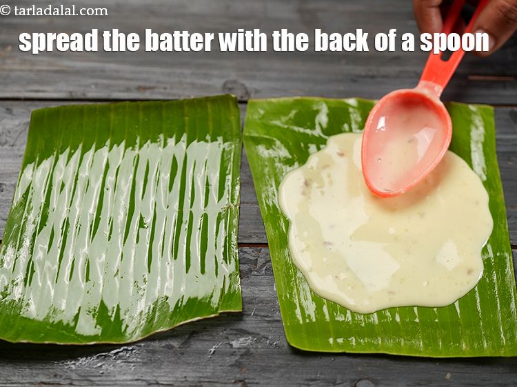 Step 23 – <meta charset="UTF-8" />Spread the batter with the back of a spoon on the banana leaf.&nbsp;&nbsp;